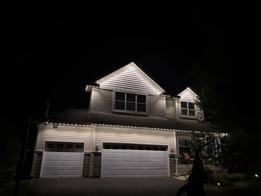 Warm white permanent roofline lighting after dark