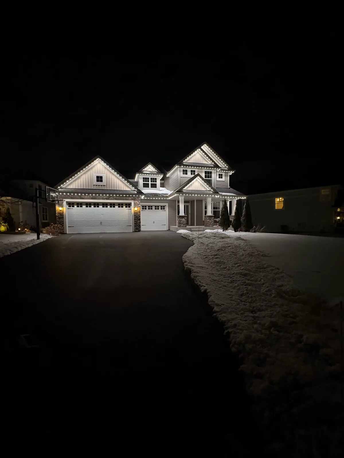 Permanent roofline lighting illuminated at night